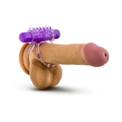 Purple vibrating double strap cockring displayed on a realistic penis model against a white background.