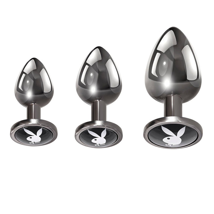 Set of three hematite metal anal plugs in small, medium, and large sizes with black bases featuring the Playboy Rabbit Head logo.
