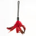 Red and black feather tickler with a black wrist loop for playful sensory stimulation.