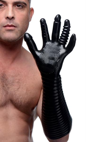 Man wearing a black extra long textured glove with varied finger shapes and ribbed forearm for enhanced stimulation.