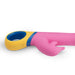 Pink silicone dolphin vibrator with yellow and blue ergonomic handle and control buttons on white background.