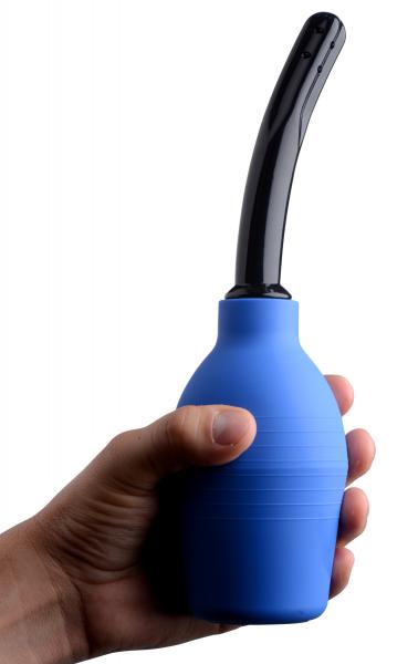 Hand holding a blue enema bulb with a curved black nozzle designed for comfortable and controlled use.