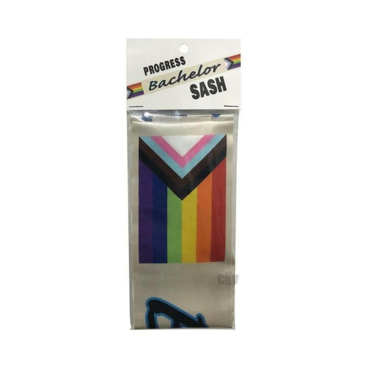 Progress Bachelor sash in packaging featuring the vibrant Progress Pride Flag design with inclusive rainbow colors.