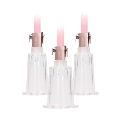 Rose gold clitoral and nipple pump set with three clear acrylic cylinders and pink tubing attachments.