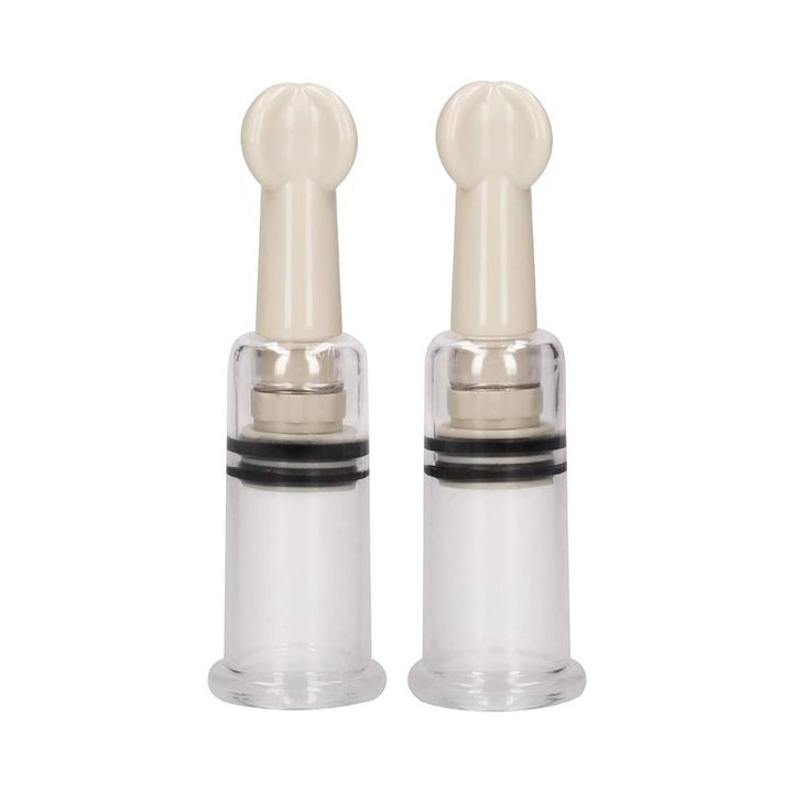 Pair of small transparent nipple suction cups with beige twist tops for adjustable pressure.