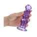 Hand holding a purple crystal clear curvy 5.5 inch dildo with suction base for hands-free use.