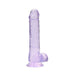 Translucent lavender realistic dildo with balls and suction cup base standing upright on white background.