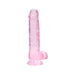 Pink translucent realistic dildo with balls and suction cup base standing upright on white background.