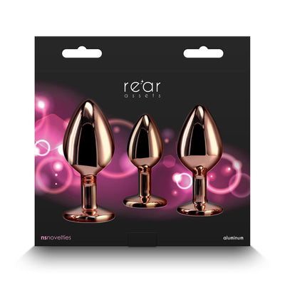 Three polished rose gold aluminum plugs in small, medium, and large sizes displayed on black packaging with pink accents.