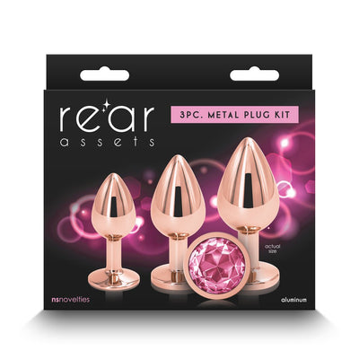 Rear Assets 3-piece rose gold metal plug kit with graduated sizes and pink gem detail on black packaging.