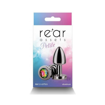 Petite metal anal plug in gunmetal with rainbow gem base displayed on colorful packaging background