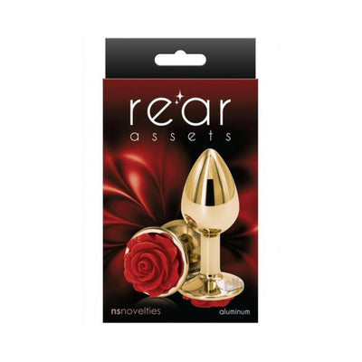 Small gold-toned aluminum butt plug with a decorative red rose base displayed on product packaging.