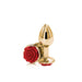 Small gold-toned metal butt plug with a decorative red rose base, polished and reflective surface.