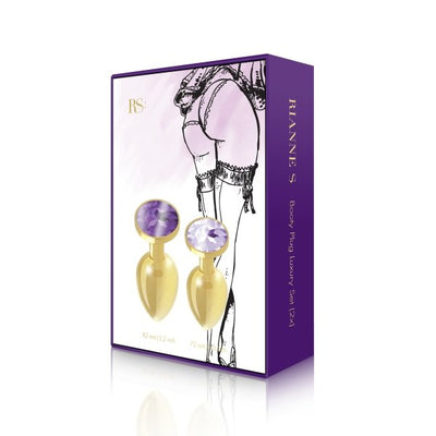 Rianne S gold plated metal butt plug set with purple gem accents in two sizes, displayed in elegant purple packaging.