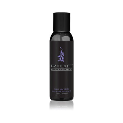 Black 2 oz bottle of Ride Bodyworx Silk Hybrid personal lubricant with purple logo and text on white background.