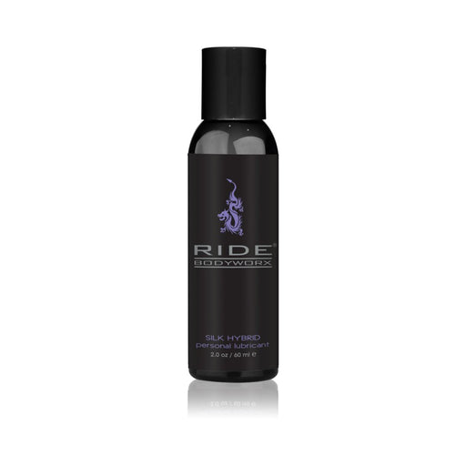 Black 2 oz bottle of Ride Bodyworx Silk Hybrid personal lubricant with purple logo and text on white background.