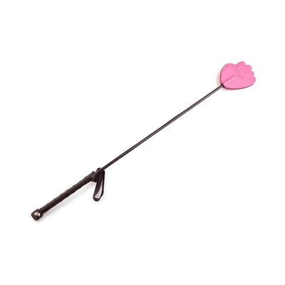 Black leather riding crop with a pink hand-shaped tip and wrapped grip handle with wrist strap.