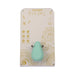 Mint green Ritual Chi rechargeable silicone clitoral vibrator displayed on decorative beige and gold packaging.
