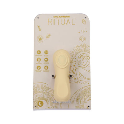 Compact yellow rechargeable silicone vibrator displayed on decorative branded packaging with gold accents and product features.