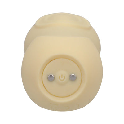 Close-up of the yellow Ritual Sol rechargeable silicone pulsating vibrator showing the power button and magnetic charging points.