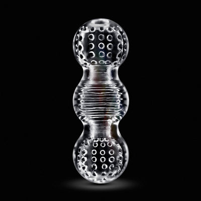Clear textured dual-chamber silicone toy with raised nubs and ribbed middle section on black background.