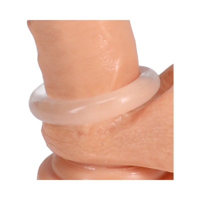 Close-up of a translucent soft silicone ring worn around the base of a realistic skin-toned model.