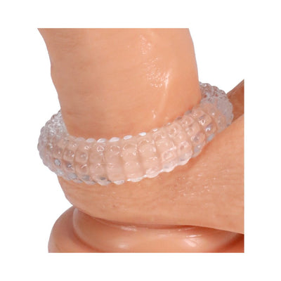 Clear textured stretchy ring worn on a silicone model, showcasing flexible ridged design.