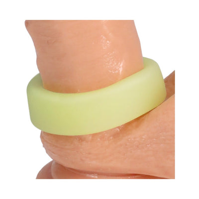 Close-up of a glow-in-the-dark pale green silicone ring worn on a finger.