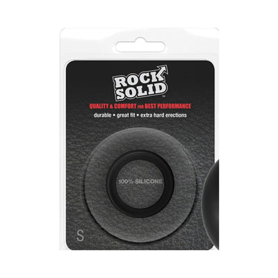 Small black silicone ring in clear clamshell packaging with Rock Solid branding and product details.