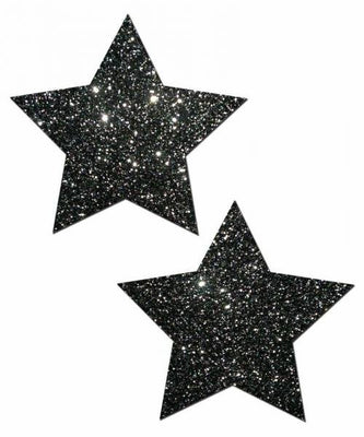 Pair of black glitter star-shaped adhesive pasties on white background