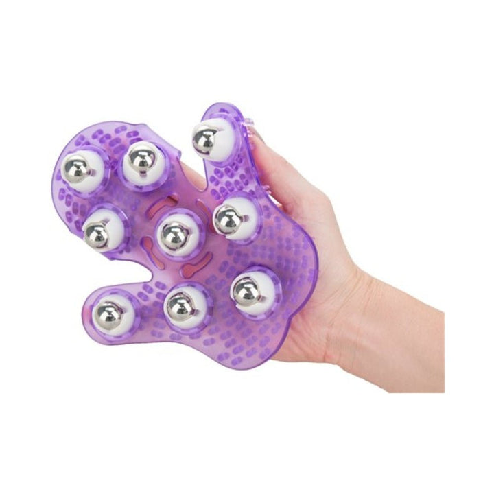 Hand holding a purple massage glove with nine silver rolling balls and textured surface for soothing massages.