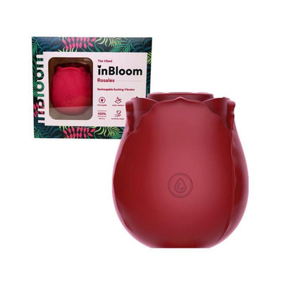 Rose-shaped red silicone inBloom Rosales rechargeable suction vibrator with packaging box in background.