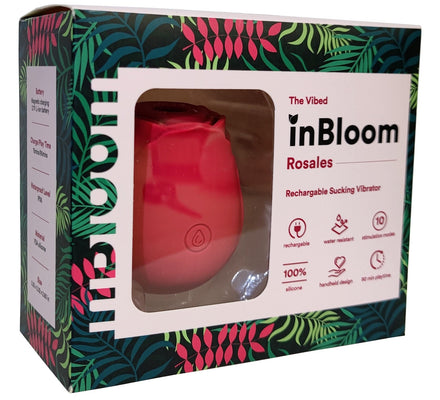 In Bloom Rosales rose-shaped rechargeable suction vibrator in red with tropical leaf patterned packaging.