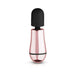 Compact rosy gold mini massager with a soft black silicone head and sleek ergonomic design.
