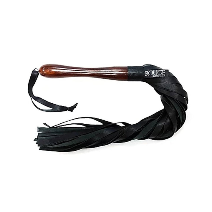 Black leather flogger with multiple tassels and polished wooden handle with wrist loop on white background.