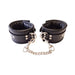 Black padded leather ankle cuffs with adjustable buckles and detachable silver chain connectors.