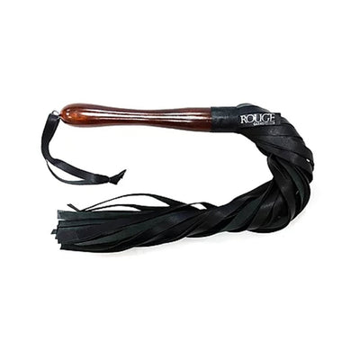 Flogger with polished wooden handle and multiple black leather tassels, featuring a wrist strap for secure grip.
