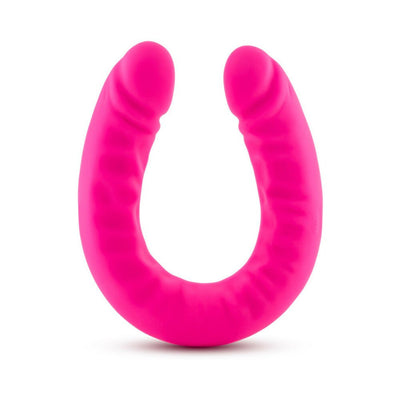 Bright pink double-ended silicone dildo with a slim, curved design and textured surface.