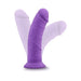 Purple curved dildo with suction cup base shown in multiple angled positions on white background.