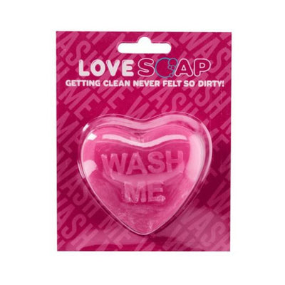 Heart-shaped pink soap bar with "WASH ME" embossed, packaged on a vibrant pink card with playful text.