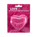 Heart-shaped pink soap bar with "WASH ME" embossed, packaged on a vibrant pink card with playful text.