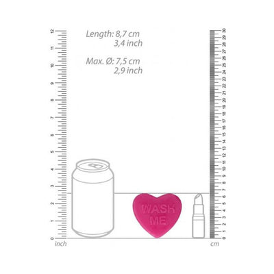 Pink heart-shaped soap with the words "WASH ME" embossed, shown with size comparison to a soda can and lipstick.