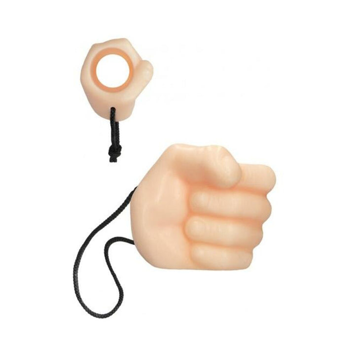 Beige soap shaped like a closed fist with a black rope loop for hanging in the shower.