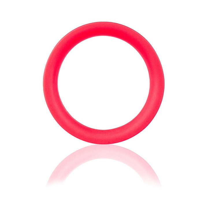 Red flexible silicone ring with smooth surface and reflective shadow on white background.