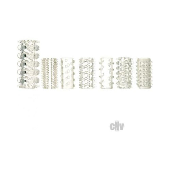 Set of seven clear textured silicone sleeves with varied raised patterns for enhanced sensation and versatile use.