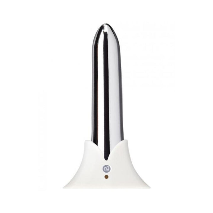 Sleek silver rechargeable bullet vibrator with tapered tip, standing upright in a white charging base.
