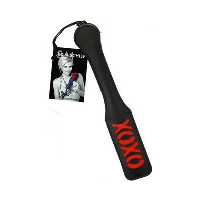 Black vinyl paddle with red XOXO design and attached Sex and Mischief branded tag.