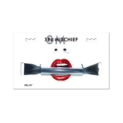 Sex & Mischief Silky Bit Gag with black silky sash displayed on white packaging featuring red lips graphic.