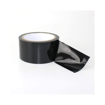 Roll of glossy black bondage tape with a loose end partially unrolled on a white background