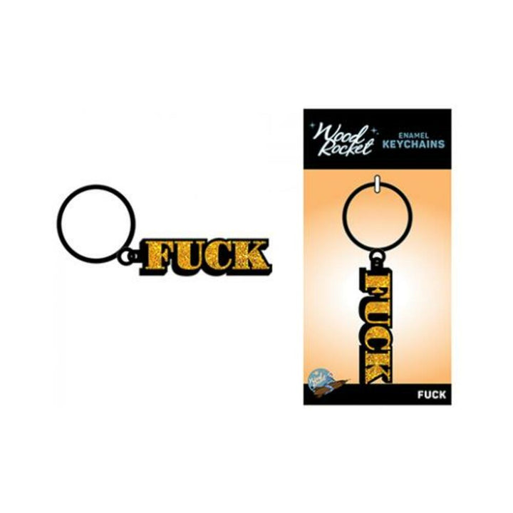 Black and gold glitter enamel keychain with bold lettering attached to a metal ring, shown on and off packaging.